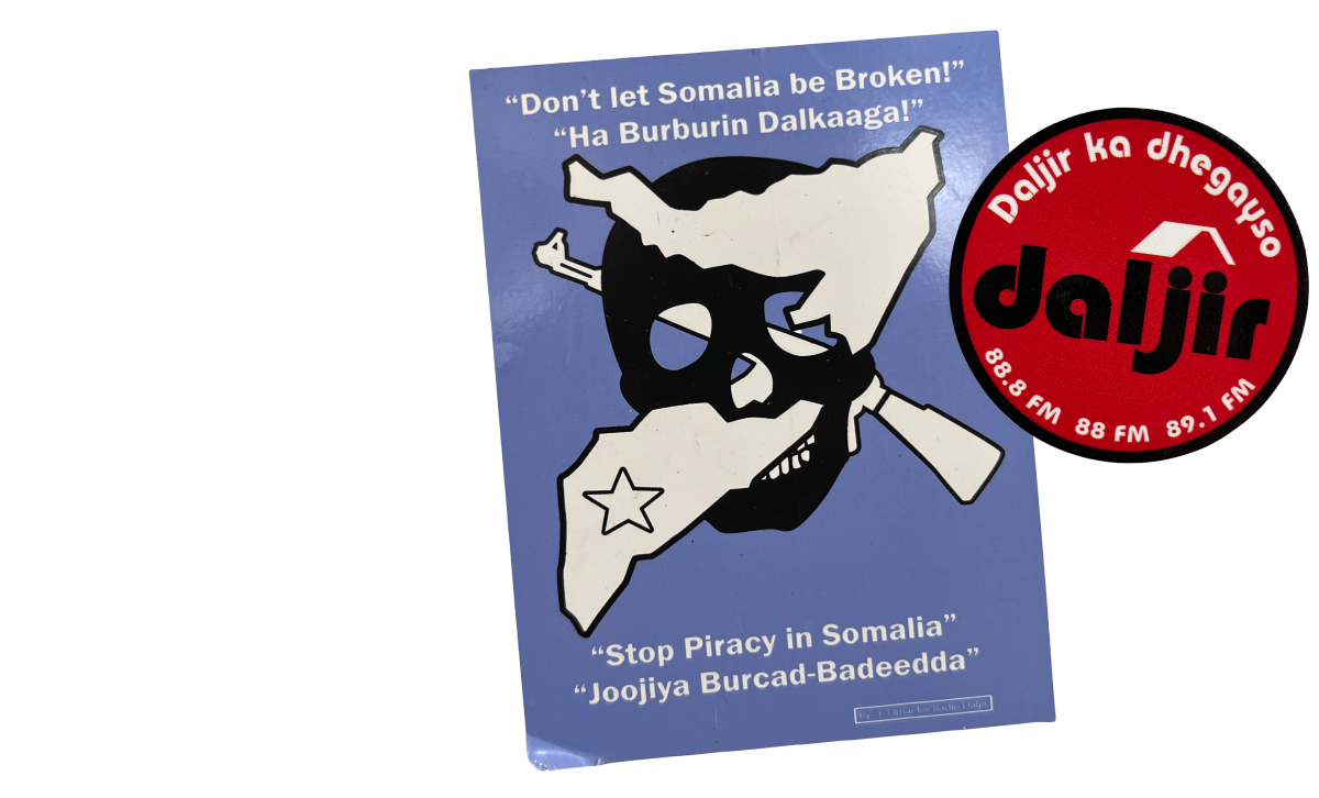 Two stickers are shown in a collage in the right column. One sticker is a rectangle with a light blue background. It has a black skull clip art with a white silhouette of a gun and the boundaries of Somalia crossing through the sockets of the skull. At the top of the sticker in white text in english it reads, “Don’t let Somalia be Broken!” under this text is a translated version in Somali. At the footer of the sticker the white text reads, “Stop Piracy in Somalia” with a translated version beneath it. 

There is a watermark for One Earth Future in the bottom right corner.

The second sticker is a circle. It is red with a black  border. White text in somali borders the top of circle while a logo reading “daljir” in black is in the middle. White text with the radio FM code is on the bottom of the sticker. 

The left column of the graphic explains, “Stickers from 
One Earth Future’s campaign against piracy in Somalia.”